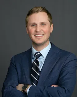 Headshot of Dr. Kenneth M. Kufta smiling in a suit and tie